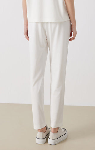White tailored pants with tapered straight-leg fit and elastic waist
