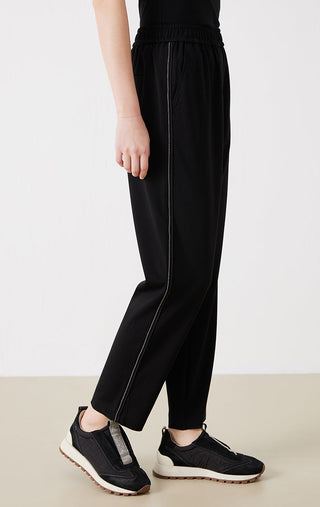 Black tapered pants with stitched side seam and elastic waist, ankle length