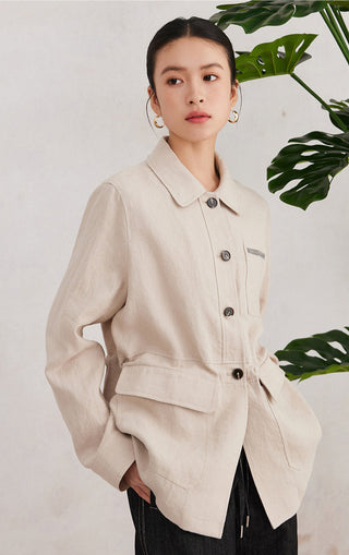 Beige linen utility shirt with button front and chest pocket, cinched waist detail