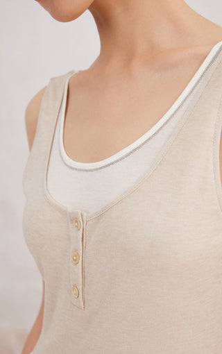 Close-up of beige tank top scoop neckline and button placket trim