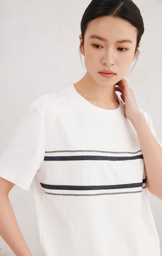 Close-up of white cotton stretch T-shirt with double beaded stripe across front