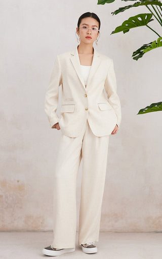 Beige tailored blazer with flap pockets and gold buttons, long sleeves
