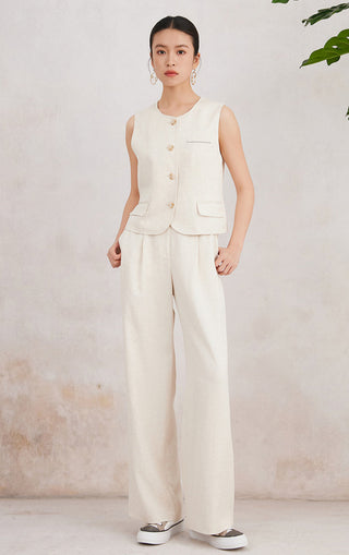 Natural linen sleeveless vest worn with light matching trousers