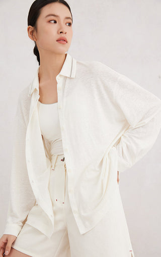 White button-up shirt worn open over camisole, beaded collar trim, long sleeves