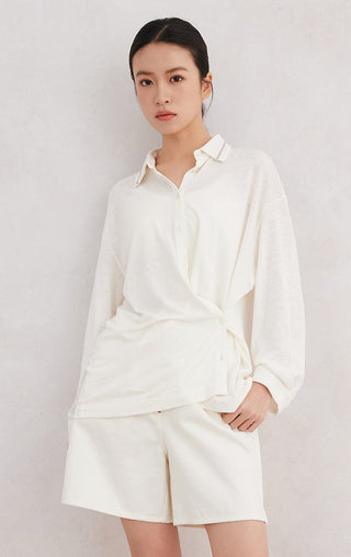 White button-up shirt front view with beaded collar trim and button front