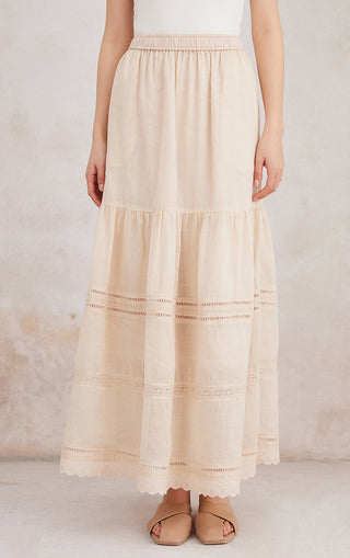 Beige tiered ramie maxi skirt with elastic waist, horizontal stitch panels, and scallop hem