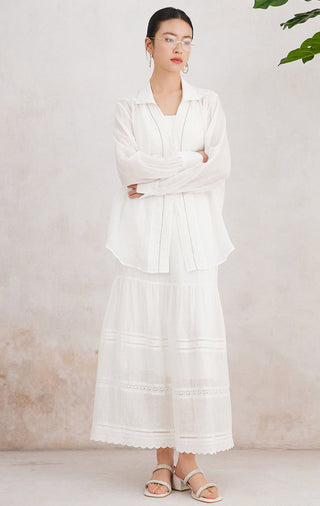 White ramie tiered maxi skirt with elastic waist, tiered ruffles, and embroidered stripe trim