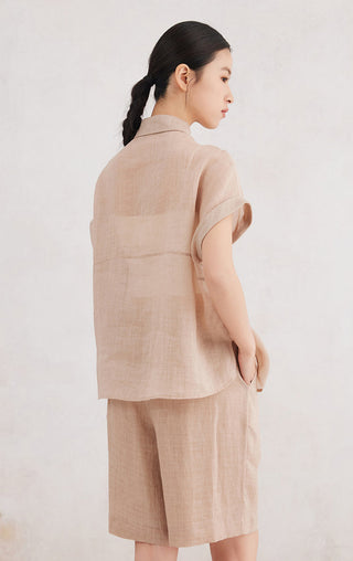 Apricot short-sleeve button-up shirt back view, vertical seam and curved hem.