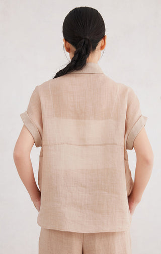 Apricot short-sleeve button-up shirt, back view with yoke seam at shoulders.