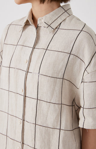 Close-up white linen shirt with button placket and dark grid stitch lines