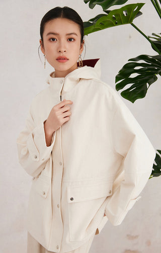 Beige cotton hooded jacket three-quarter view with adjustable hood and front pockets
