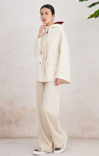Beige cotton hooded jacket with drawstring hood, flap pockets, and snap front