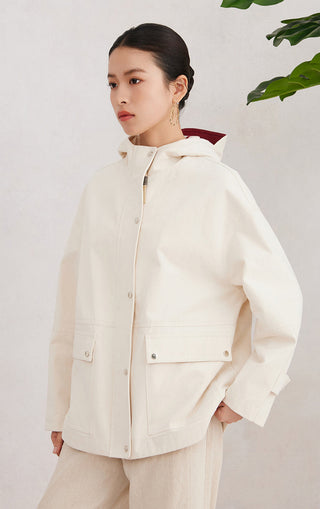 Beige cotton hooded jacket side view with buttoned flap pockets and snap placket