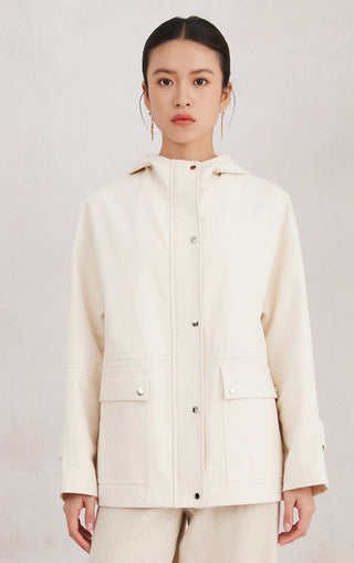 Beige cotton hooded jacket with shiny zipper, flap pockets, and snap buttons