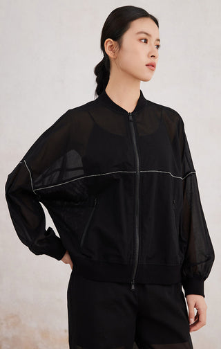 Black zip-up hoodie, side view, contrast piping and front pocket zips