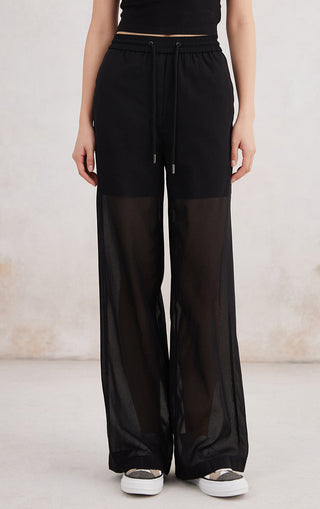 Black cotton slim straight pants with elastic drawstring waist and sheer lower panels