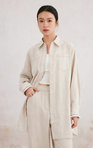 Beige linen button-front shirt with open collar, chest pockets, contrast cuffs