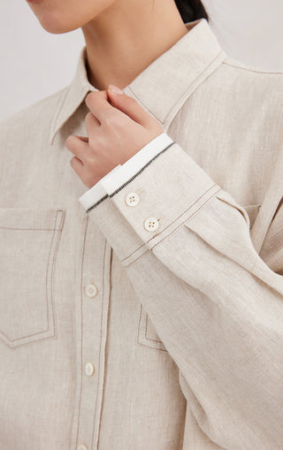 Beige linen shirt cuff with contrast trim and two-button placket