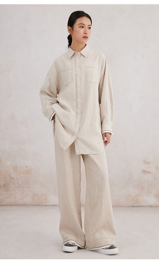 Beige linen wide-leg trousers worn with matching jacket; elastic waist and pockets