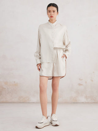 Full-length view: beige silk striped elastic-waist shorts with side slit and contrast trim