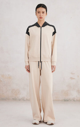 Apricot double-color zip-up hoodie with hood and contrast black sleeve panels, full outfit