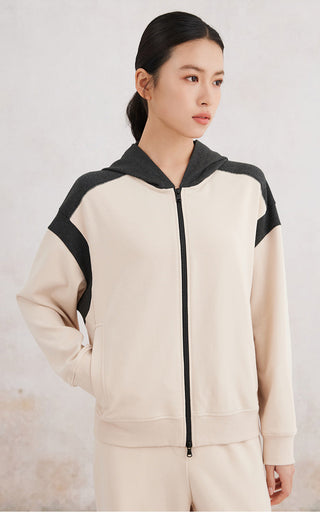 Front view apricot double-color zip-up hoodie with black sleeve panels