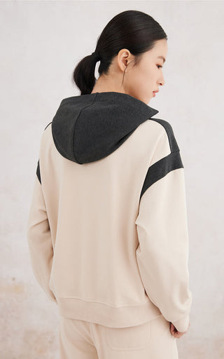 Back view apricot hoodie with black hood and contrast back panel detail
