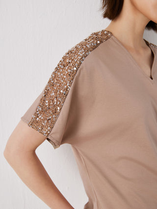Close-up: khaki V-neck top with gold-tone sequin sleeve shoulder trim