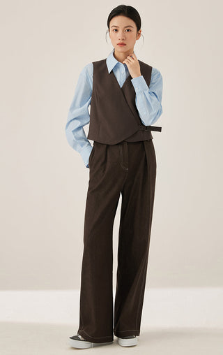 Dark brown wrap vest with V-neck and tie belt paired with wide-leg trousers