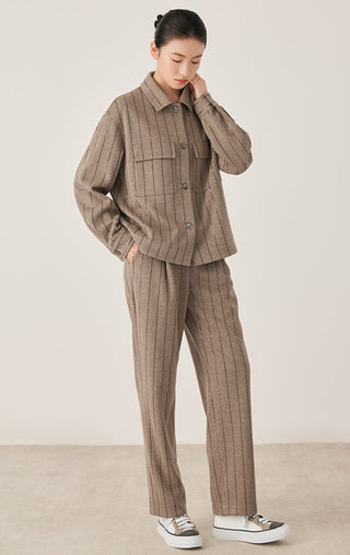 Dark camel stripe straight pants on model, full-length view, relaxed straight leg