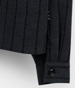 Dark grey knit sleeve with sequin-edged stripes and button cuff