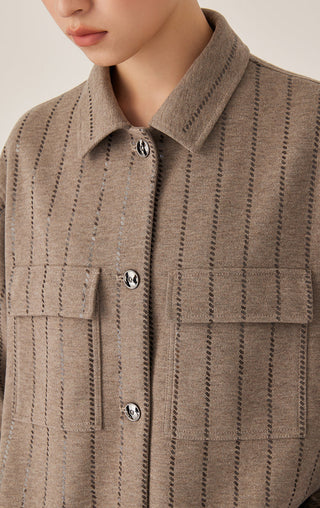 Close-up: dark camel knit shirt jacket with sequin-stitched vertical stripes and button collar