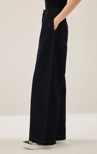 Black/dark wash wide-leg trousers side view with stitched seams and pockets.