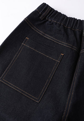 Close-up of black/dark wash wide-leg trousers: patch pocket with contrast stitching.