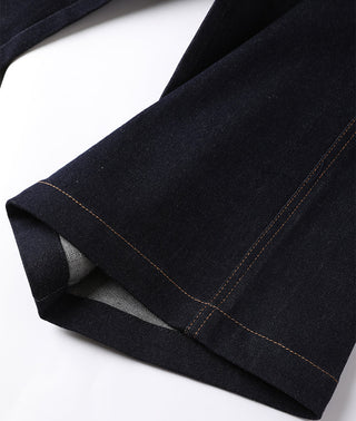 Hem detail of black/dark wash wide-leg trousers with contrast topstitching.