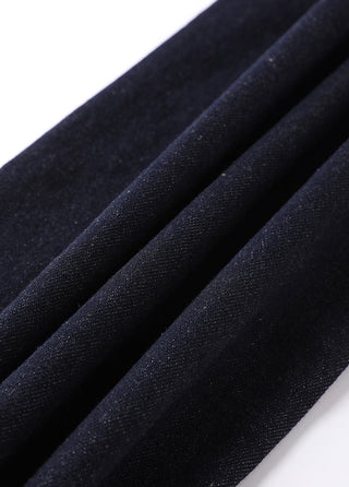 Black/dark wash denim-like fabric texture on wide-leg trousers.
