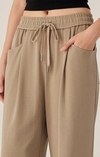 Khaki elastic waist pants with drawstring cords and adjustable tips; side pocket