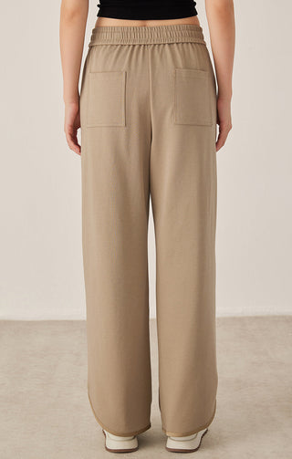 Khaki drawstring pants with back patch pockets, elastic waist, relaxed wide fit