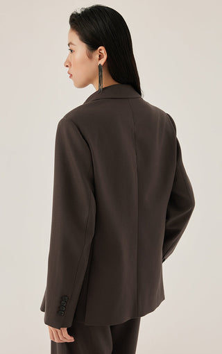 Dark brown tailored blazer back view with notched collar and cuff button detail