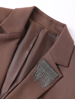 Dark brown blazer lapel detail with textured shimmer fringe accent inside.