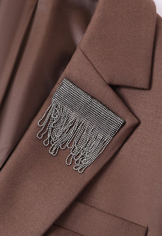 Dark brown blazer close-up: shimmer fringe panel at chest area.