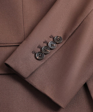 Dark brown blazer sleeve cuff close-up with four dark buttons.