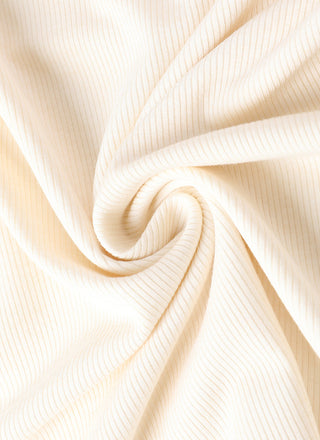 White ribbed knit fabric close-up with soft, drapey texture
