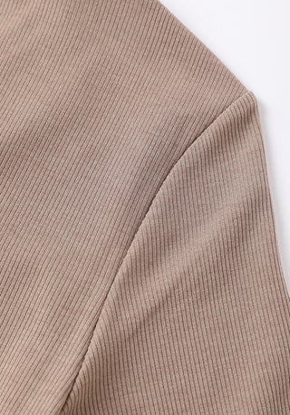 Side sleeve detail of brown ribbed-knit V-neck top