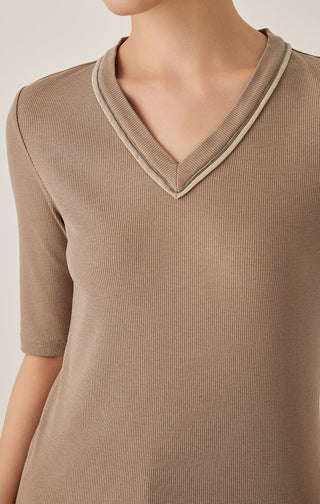 Close-up of brown V-neck top neckline with contrast edge trim