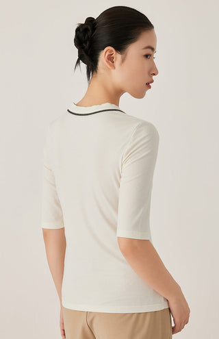 White knit top with black-trim neckline and short sleeves, back view
