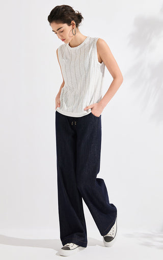 Ivory knit tank top with vertical beaded stripes, worn with wide-leg dark pants