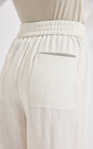 Ivory white elastic waistband and side pocket detail on wide-leg trousers