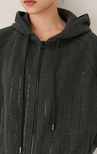 Close-up of graphite gray zip-front hooded jacket with vertical sequin detailing