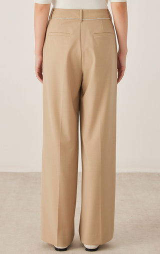 Back view of khaki tailored wide-leg pants with welt pockets and center back seam.